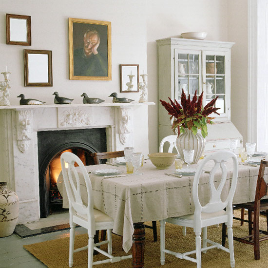 Formal dining room with table, white painted chairs and cabinet