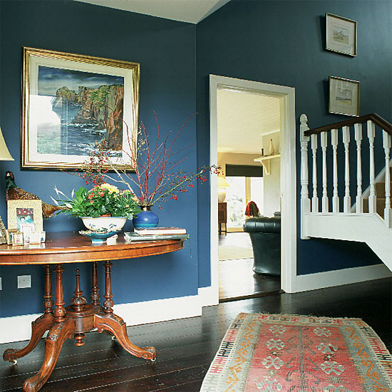 Hallway with blue walls, antique table and rug | housetohome.co.uk