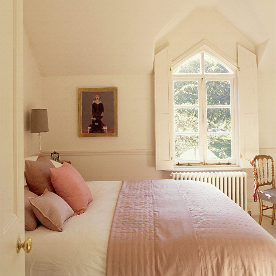 Small cream bedroom with gothic windows and silk quilt | housetohome.co.uk