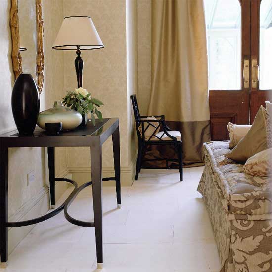 With a gilt mirror hanging above it, the table is a focal point in this large hallway