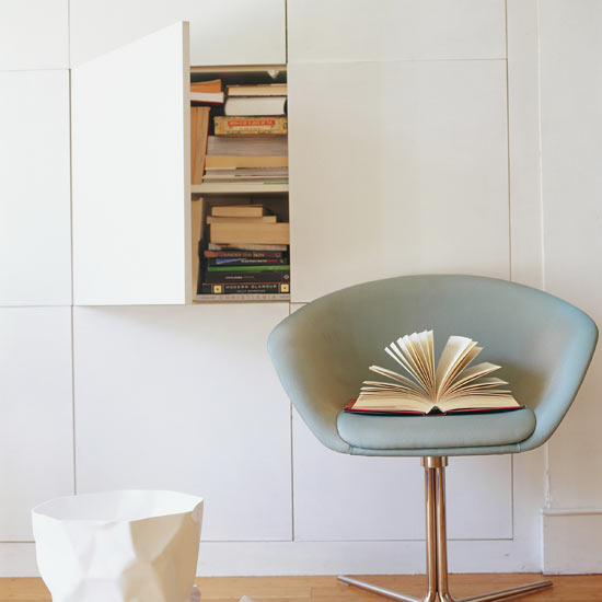 Go for the minimalist look with a bank of handleless cupboards recessed into the wall