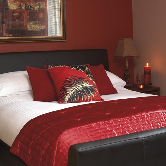 Bedroom with red feature wall, double bed with red satin throw ...