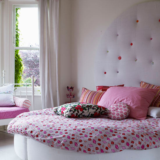 Luxurious girly bedroom with pink bedding and headboard