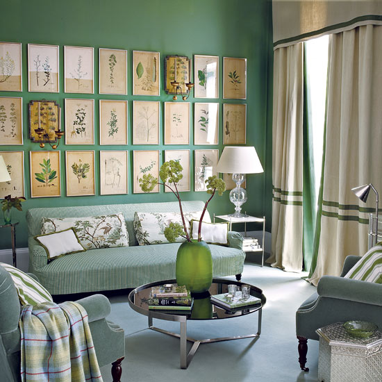 Pale accessories and soft furnishings break up the green colour palette in this living room