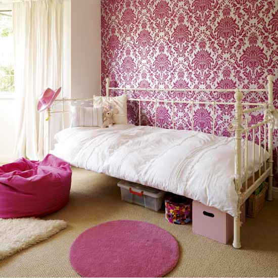 Chic girl's bedroom with feature wall and pink rug 