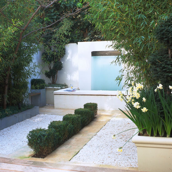 Contemporary garden with coloured gravel and stone pathways