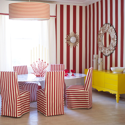 Dining room with red striped wallpaper and matching fabric chairs
