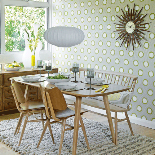 Retro dining room with geometric wallpaper and sunburst light