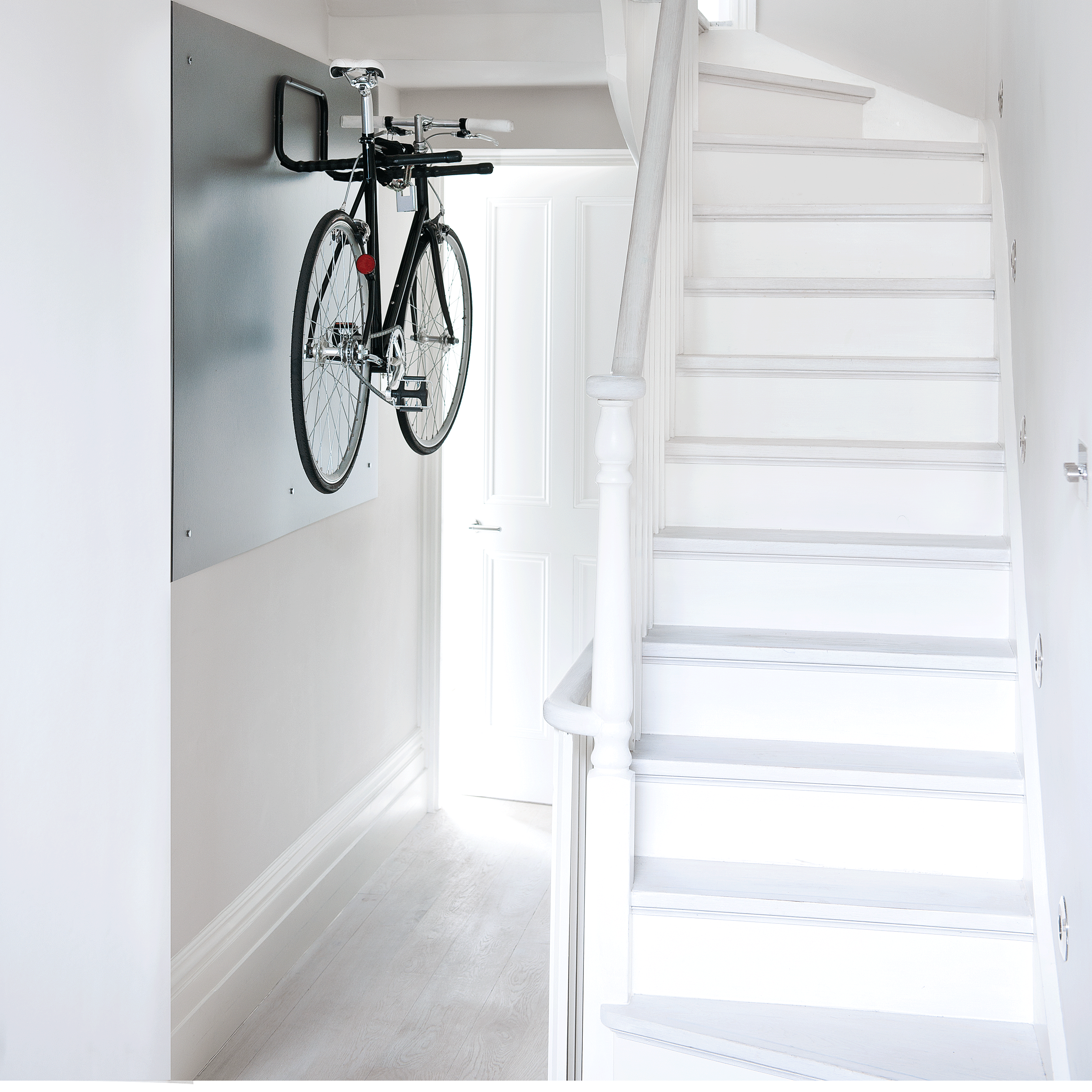 Minimal white hallway with bike
