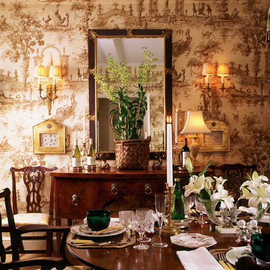 Dining room with large mirror, dining table and toile de jouy wallpaper