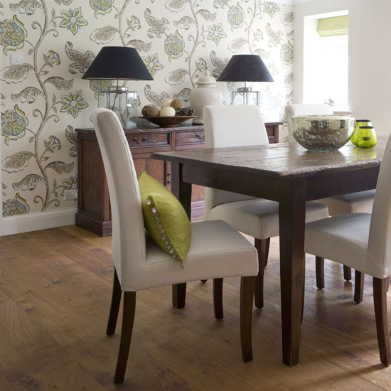 Dining room with botanical print wallpaper and wooden dining table