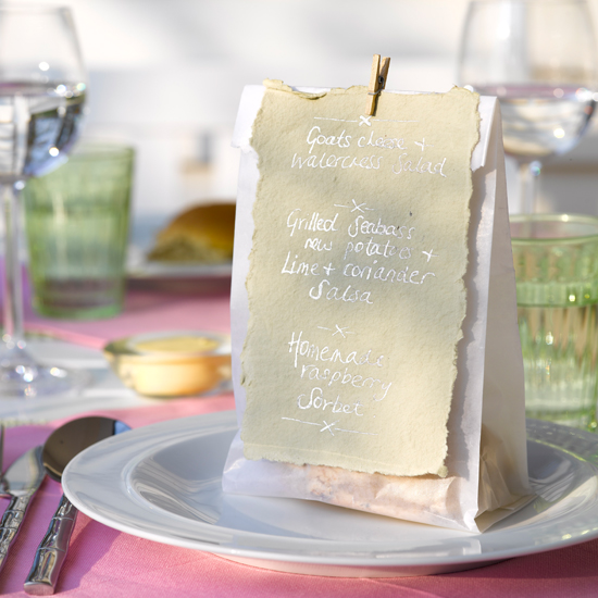 Peg little menus to bags of treats for cute table settings \ Dan Duchars