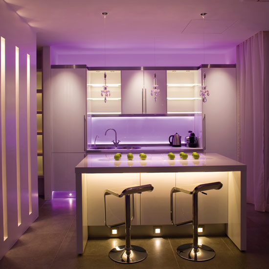 John Cullen Lighting&rsquo;s RGB Slinky, £150m, has been used behind the splashback at high and low levels. Oslo lights, £119, and Cazella 1W LEDs, £8, have been recessed 
into the plinths
