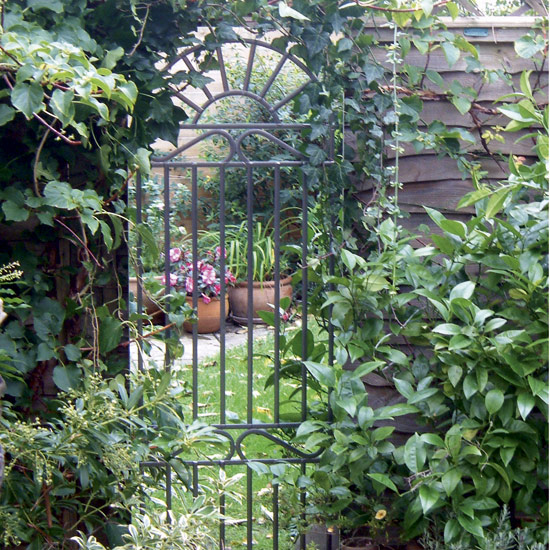 Create the illusion of a wrought-iron gate with a mirror garden gate by Looking Glass Gates