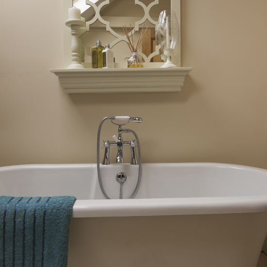 Cream bathroom with roll-top bath