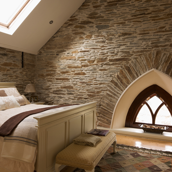 Country bedroom with exposed brick walls