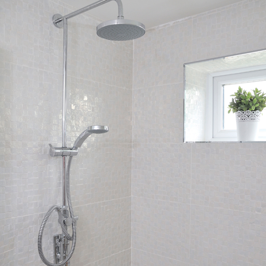 White tiled bathroom with shower