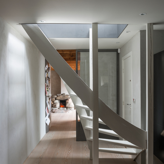 White hallway with curved staircase