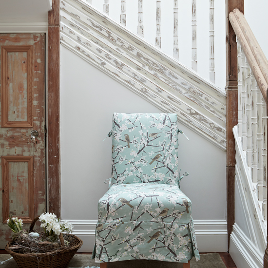 White hallway with aqua chair
