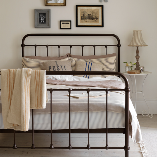 Neutral country bedroom with iron bed