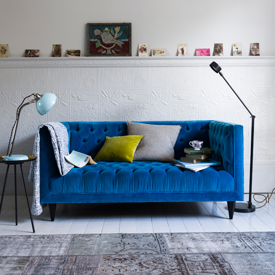Modern living room with blue velvet sofa and task lighting