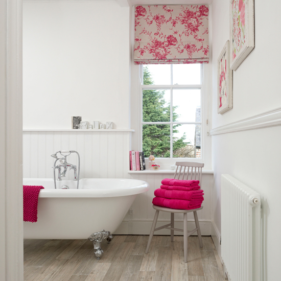 White panelled bathroom with pink accents 