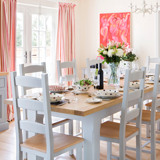 White dining room with pink and orange accents