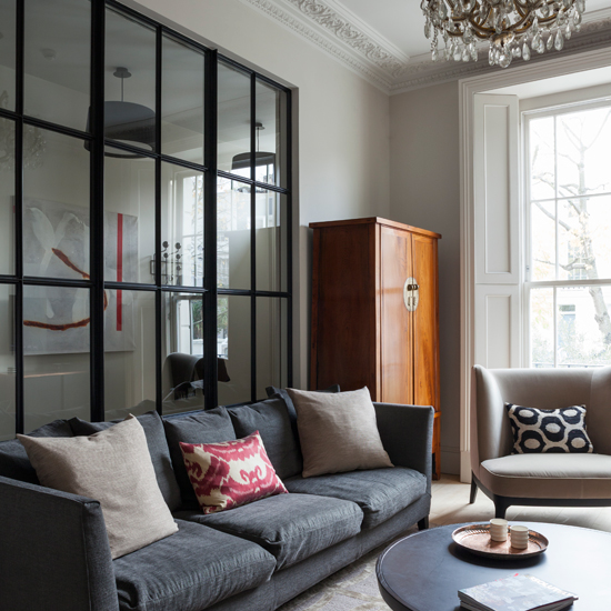 Grey living room with glass panelled wall