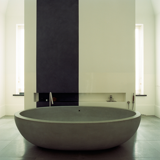 Minimalist bathroom with stone bath