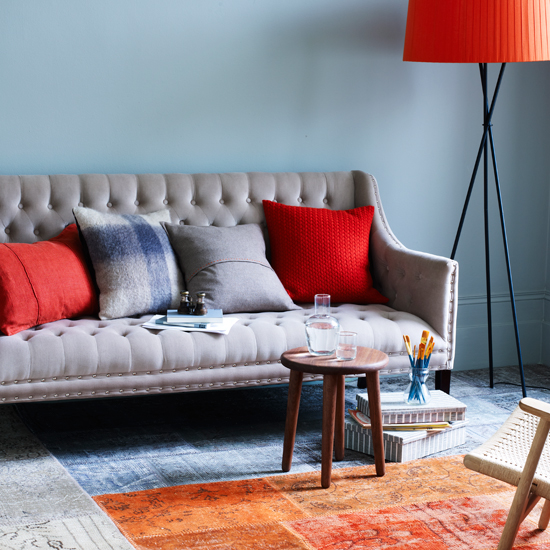 Blue and orange living room with tapestry rug