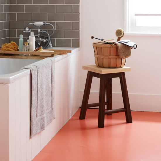 White bathroom with orange vinyl flooring 