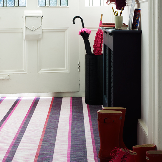 Neutral hallway with purple striped carpet