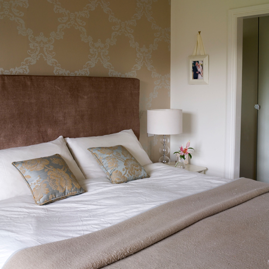 Cafe-au-lait bedroom with damask wallpaper