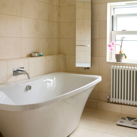 Neutral travertine tiled bathroom