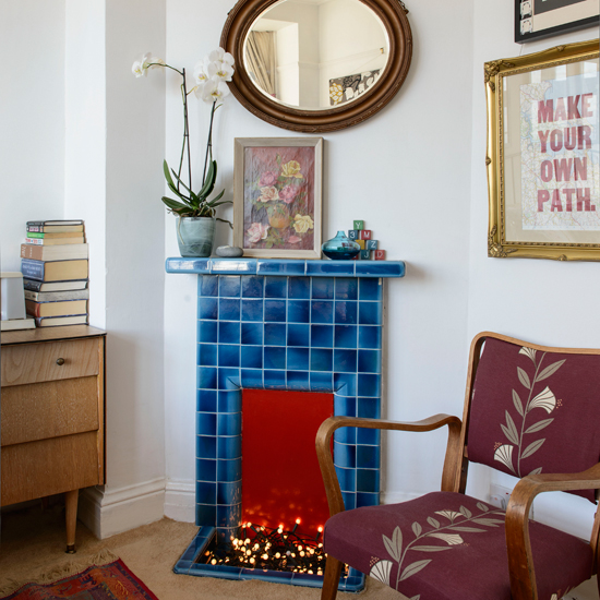 Living room with blue tiled fireplace