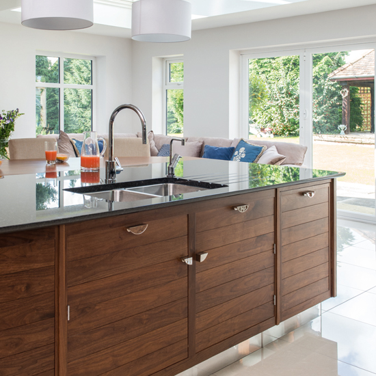 White kitchen with walnut island unit