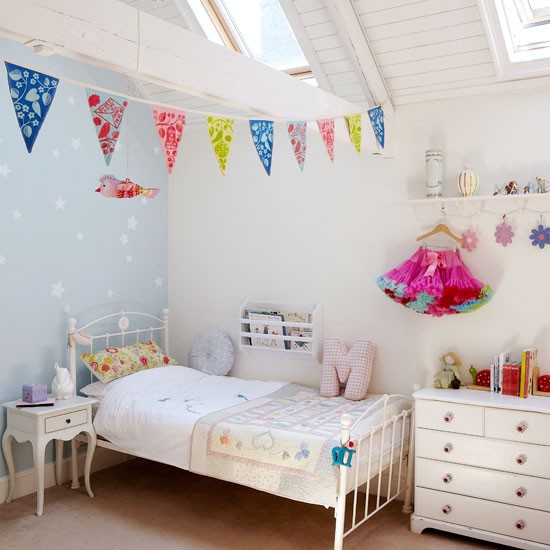 Girls bedroom with blue wall and bunting 