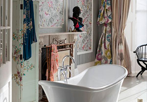 Draped curtains and dramatic wallpaper create a glamorous look