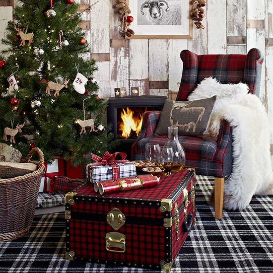 Country Christmas living room with checked carpet, tartan wing chair, tartan trunk and Christmas tree