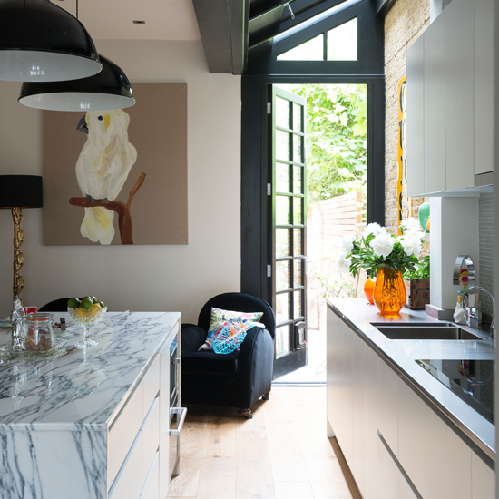Modern kitchen with marble island and artwork | Modern kitchen design