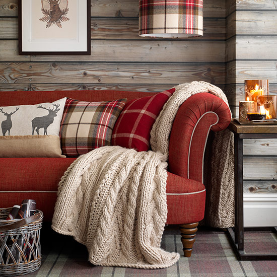 Red sofa in highland style living room  country homes and interiors  housetohome.co.uk