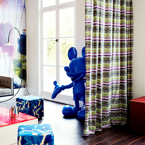 White living room with striped curtain and Mickey