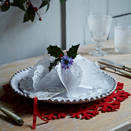 Folded doily decoration on white plate with red felt placemat  country homes and interiors  housetohome.co.uk