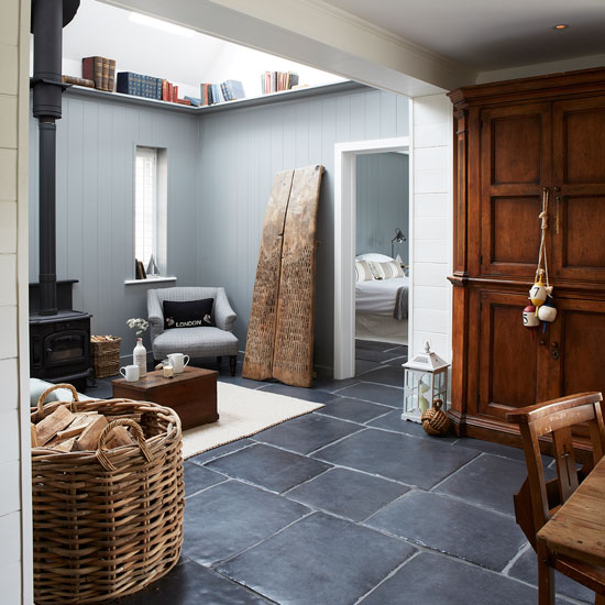 Rustic living room with wood burner and slate floor | West Sussex country house | House tour | PHOTO GALLERY | Country Homes and Interiors | Housetohome.co.uk