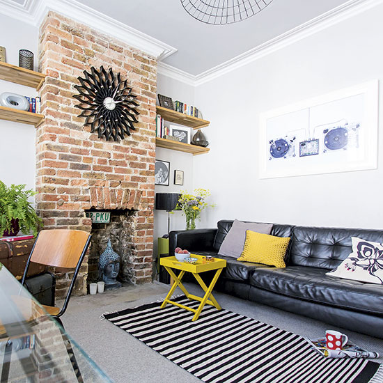 Modern living room with leather sofa and exposed brick wall