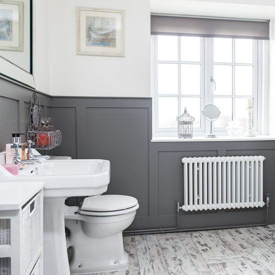 Modern bathroom with grey panelling and laminate flooring ...