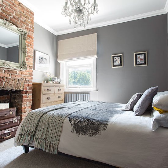 Grey bedroom with exposed fireplace and chandelier - How To Use Grey In A Bedroom: 9 Ideas To Get Started